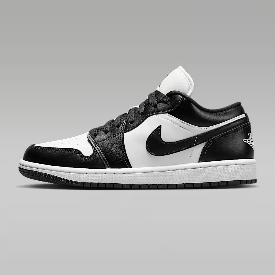 Black and white sneaker with a prominent logo on a gray background