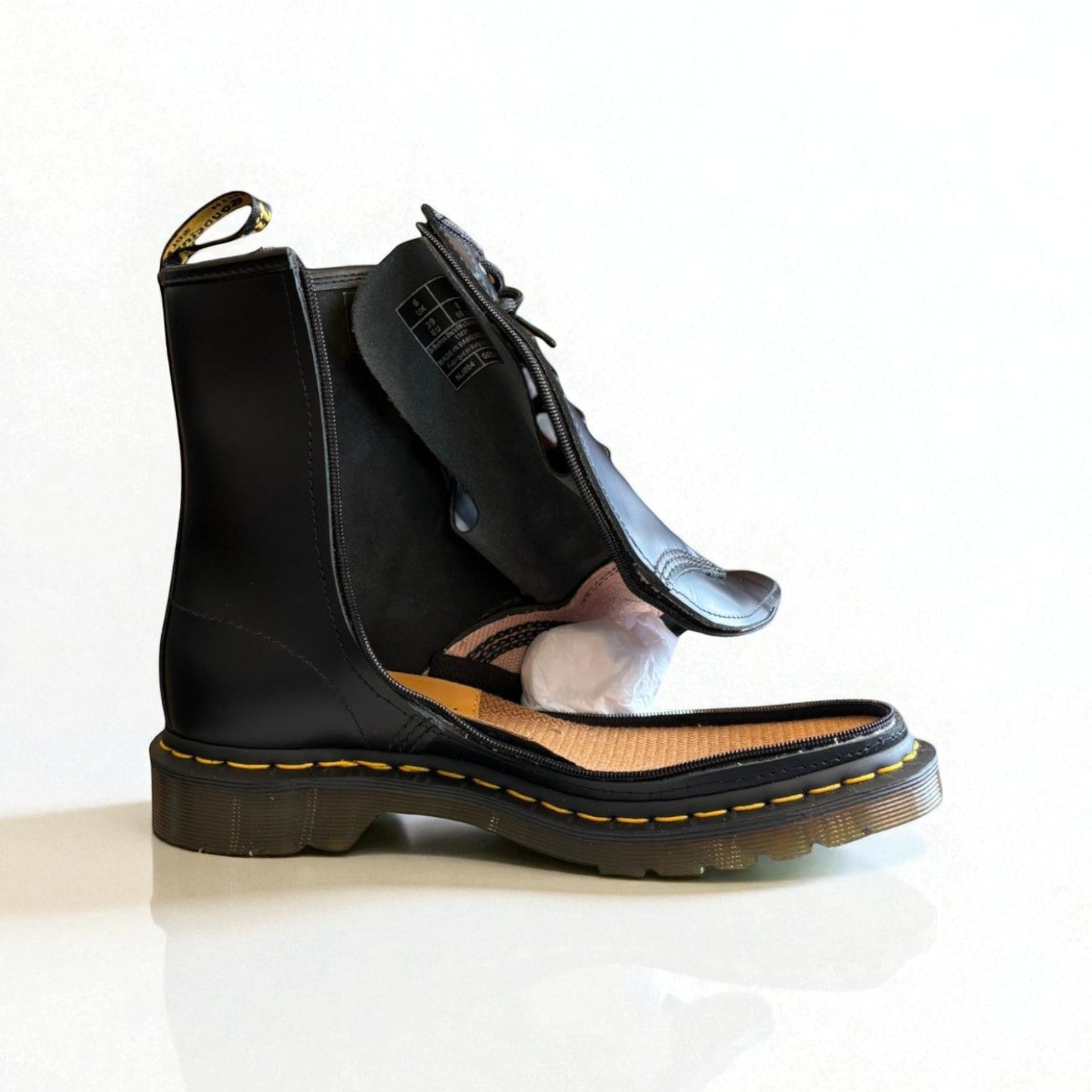 Black leather boot with zipper on a light background