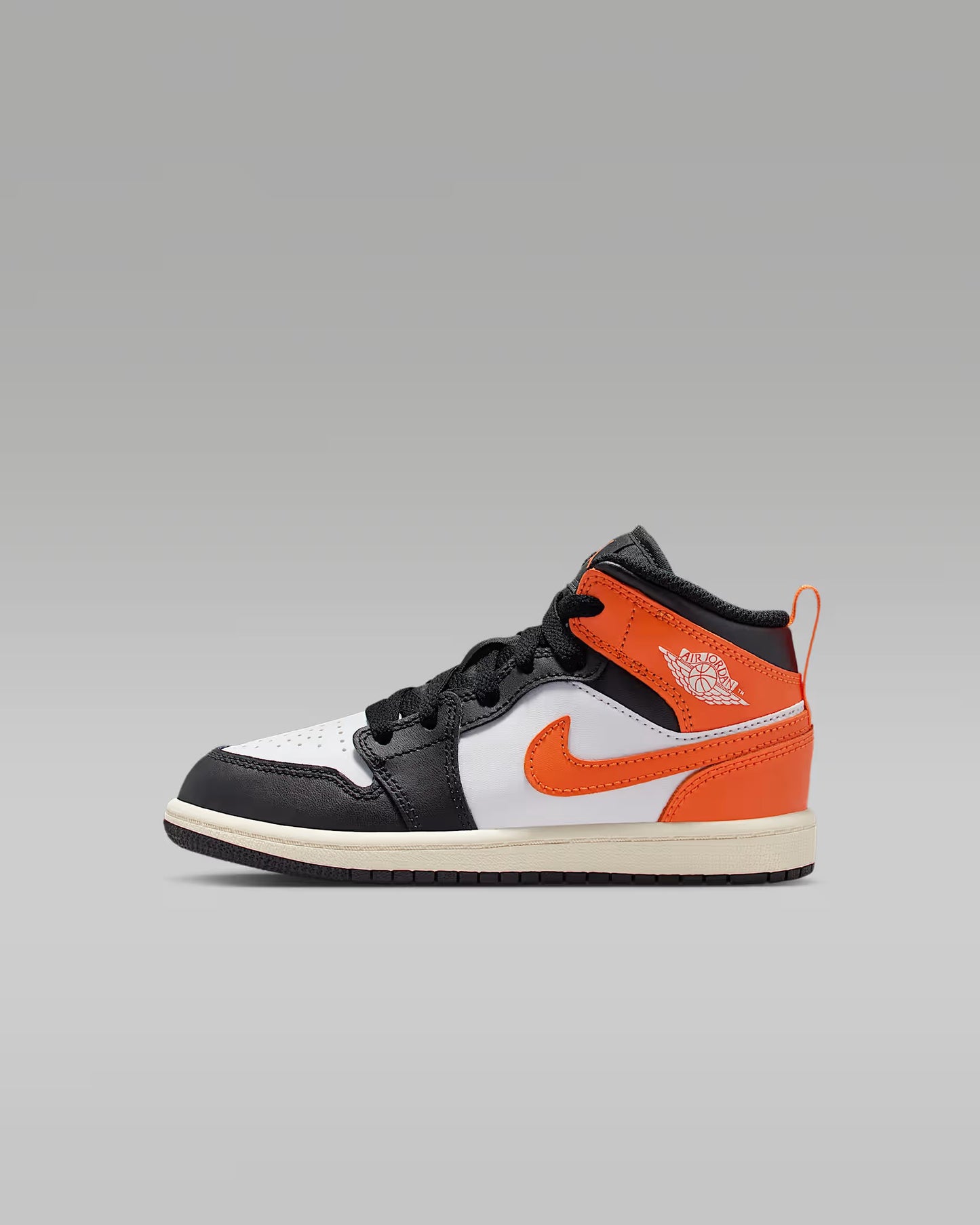 Sneaker with black, white, and orange design on a gray background