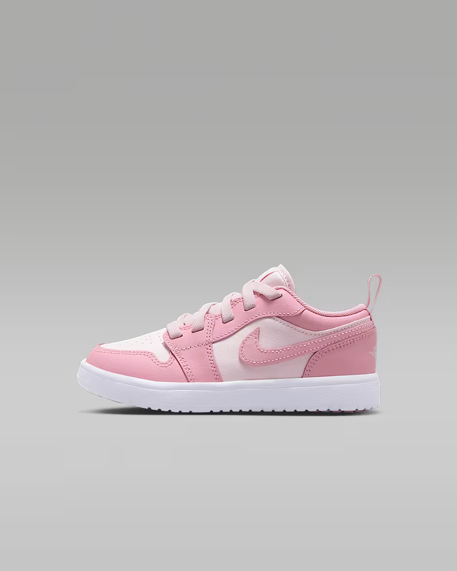 Pink and white sneaker with a brand logo on a gray background
