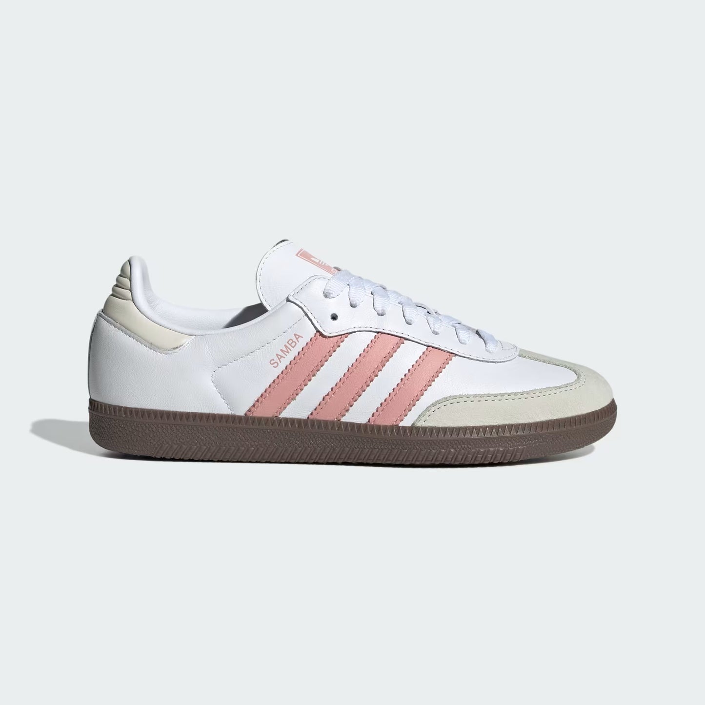 White sneaker with pink stripes on a light gray background