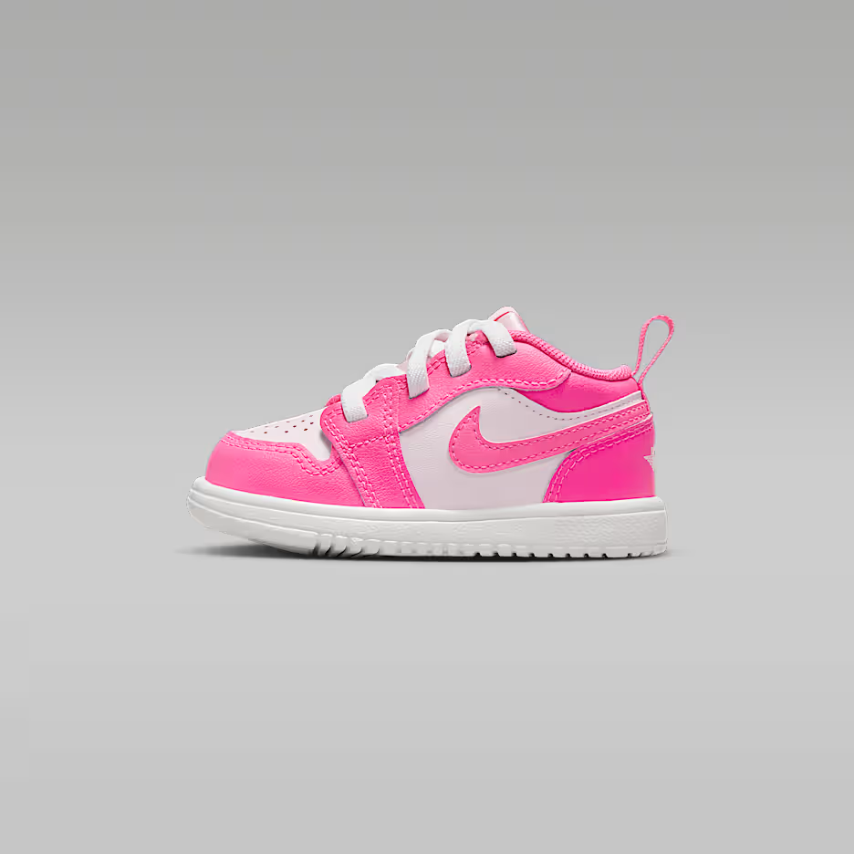 Pink and white sneaker on a gray background