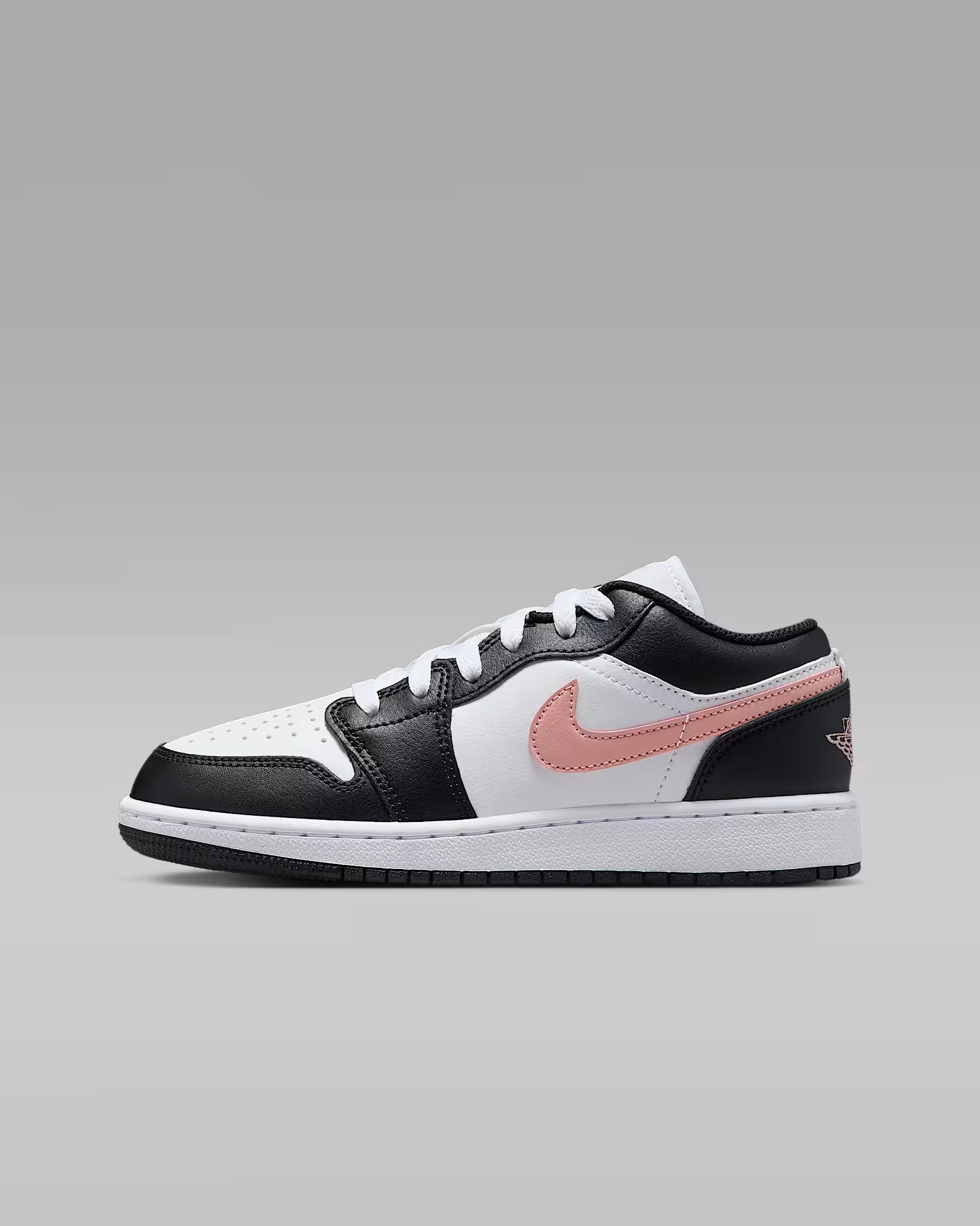 Black and white sneaker with pink swoosh logo on a gray background