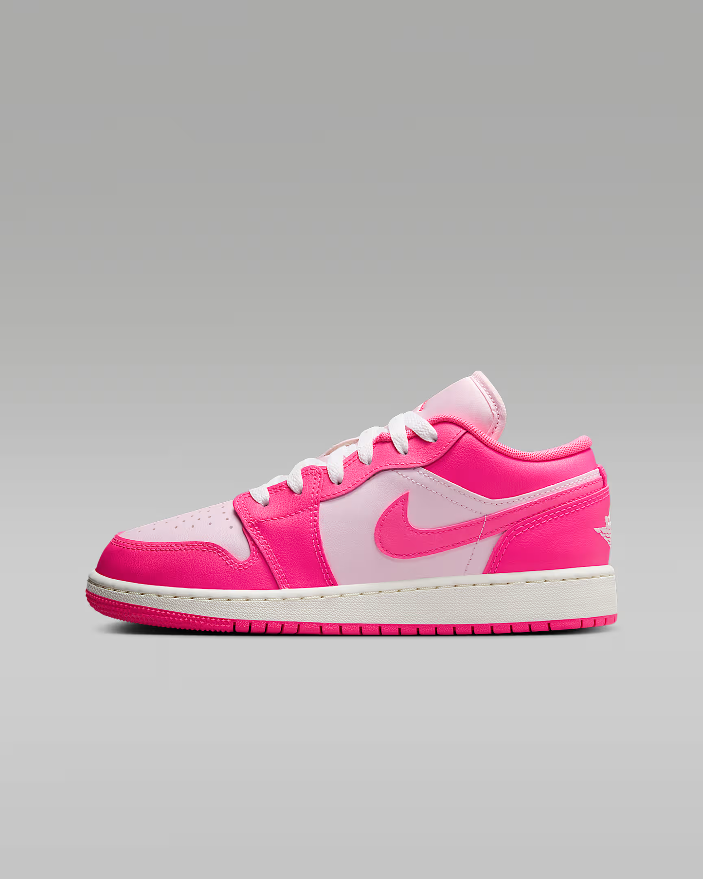 Pink and white sneaker on a gray background