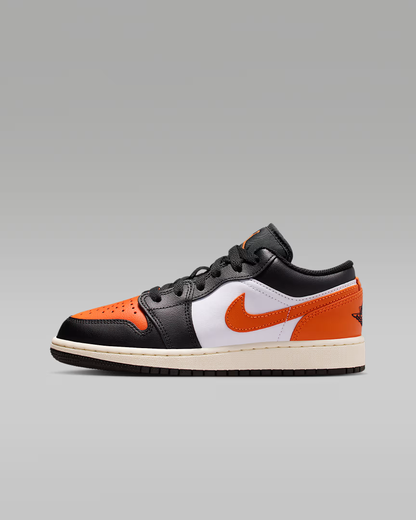Sneaker with black, orange, and white design on a gray background