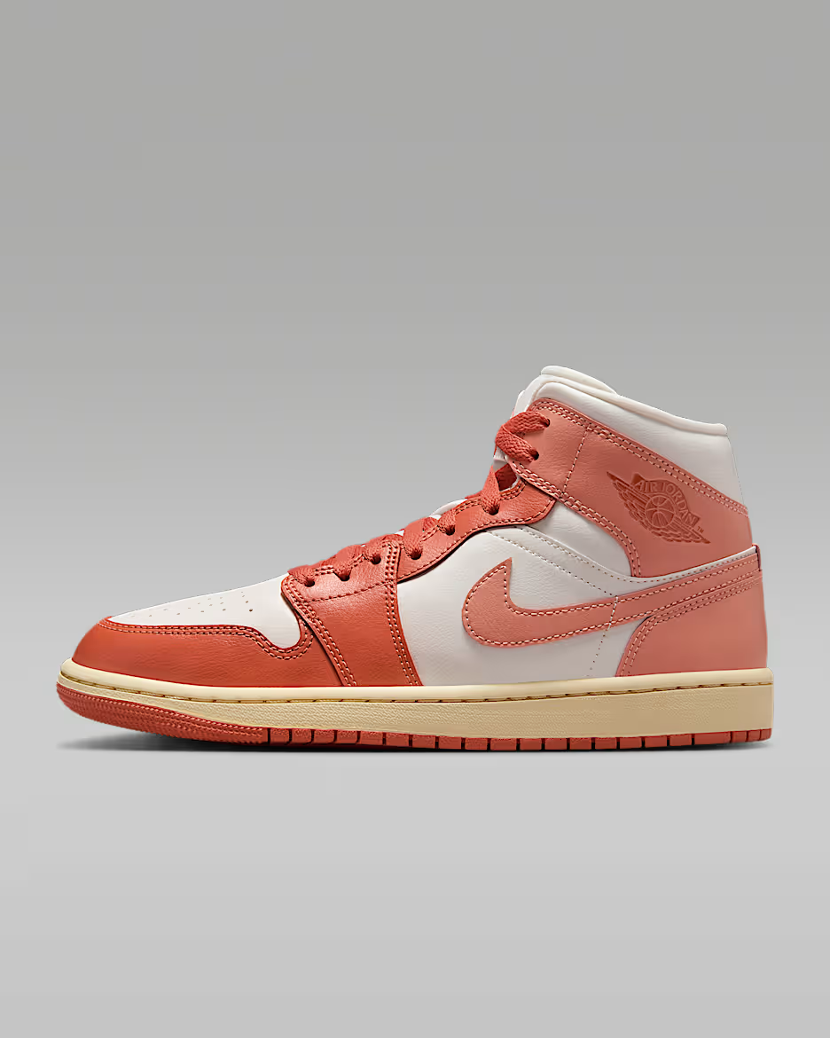 Coral and white sneaker on a gray background