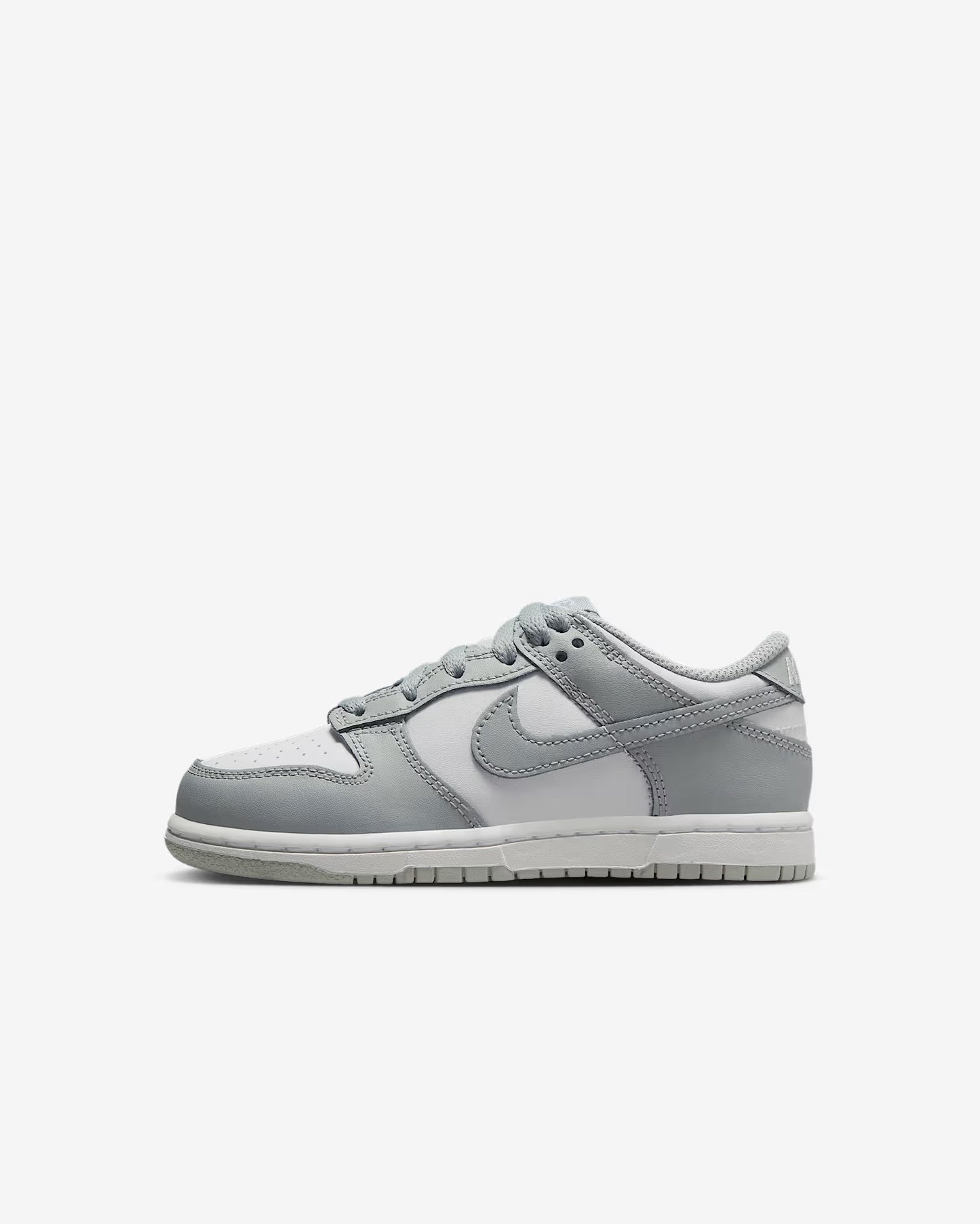 A pair of kids' Dunk Low sneakers in white and gray 