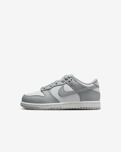 A pair of kids' Dunk Low sneakers in white and gray 
