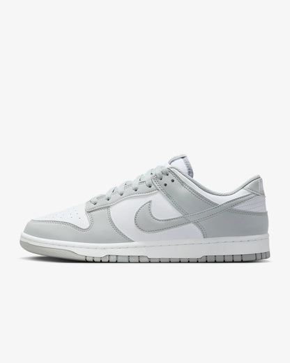 A Dunk Low sneaker with a white and gray color scheme