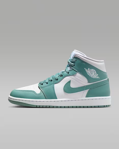 Teal and white sneaker with a logo on a gray background