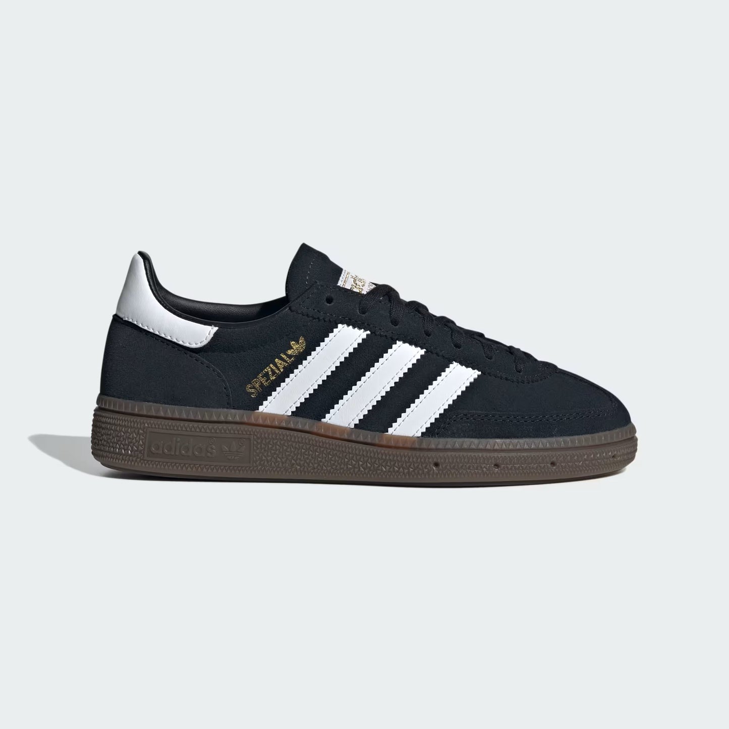 Black sneaker with white stripes on a light gray background