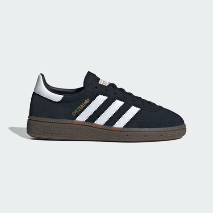 Black sneaker with white stripes on a light gray background