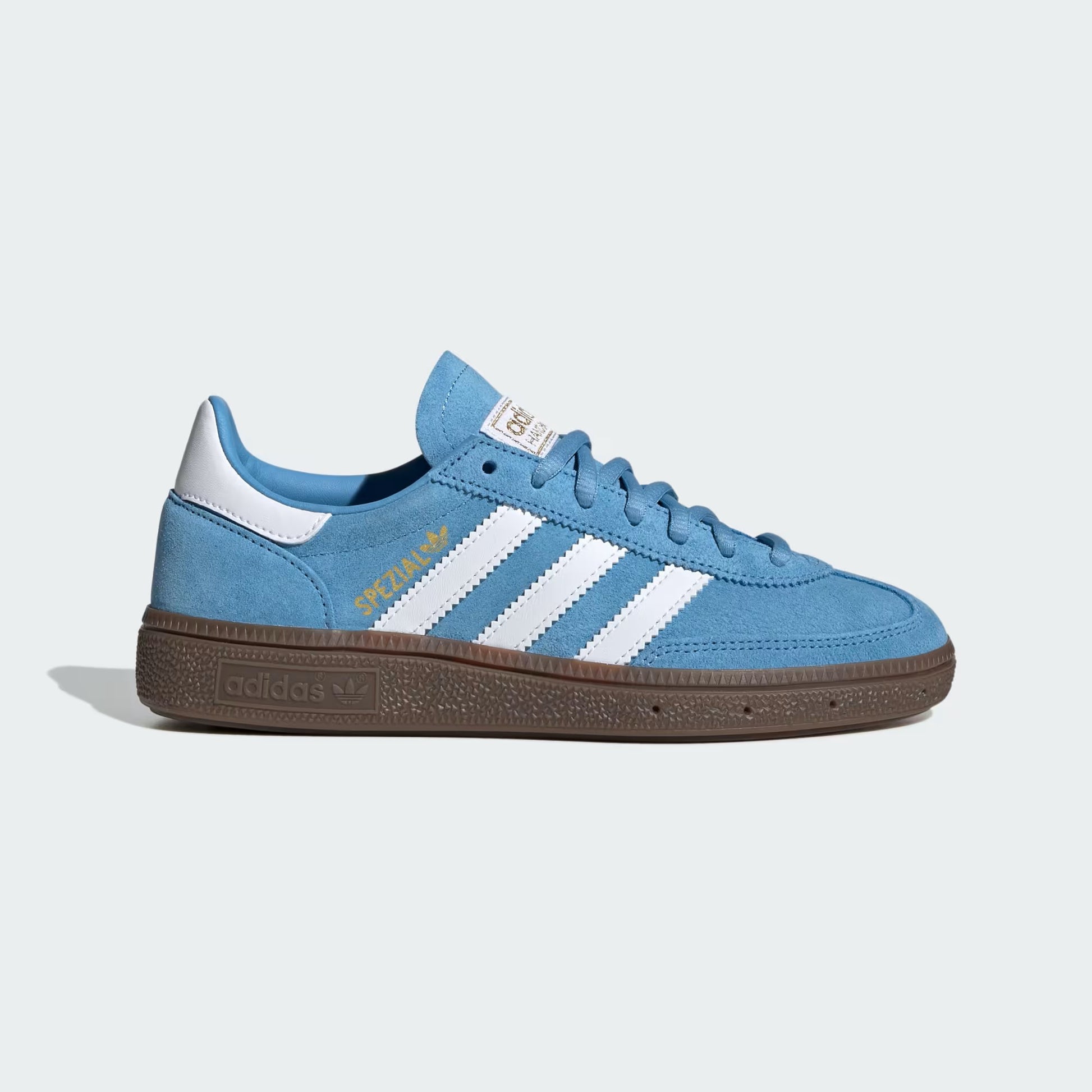 Blue sneaker with white stripes on a light gray background