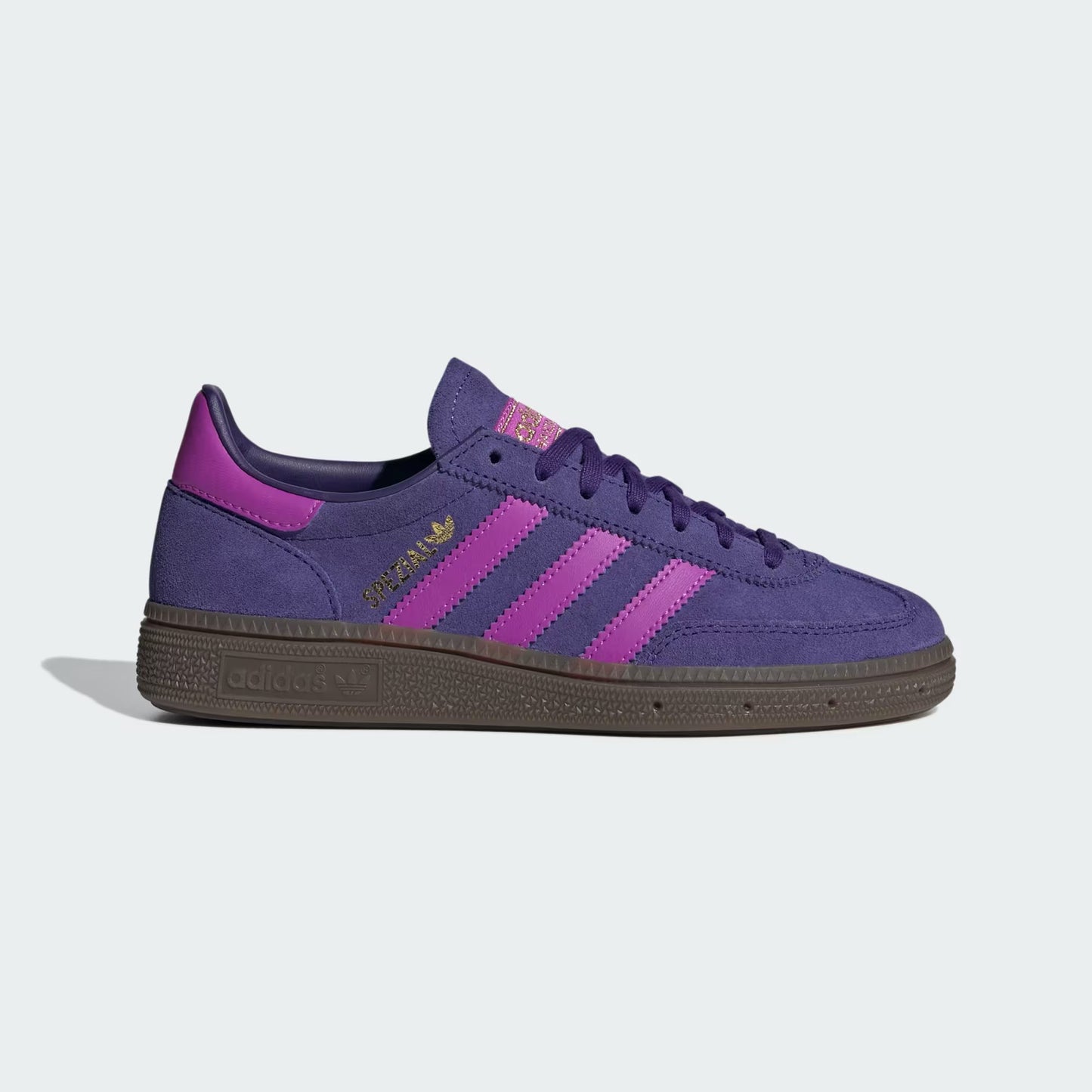 Purple sneaker with brown sole on a light gray background