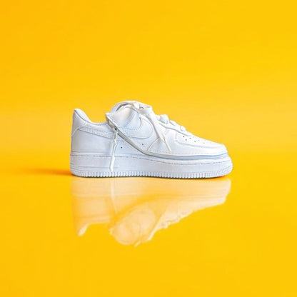 A white shoe with a zipper on a yellow background. The shoe is zipped shut