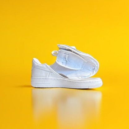 A white shoe with a zipper on a yellow background. The shoe is fully open 