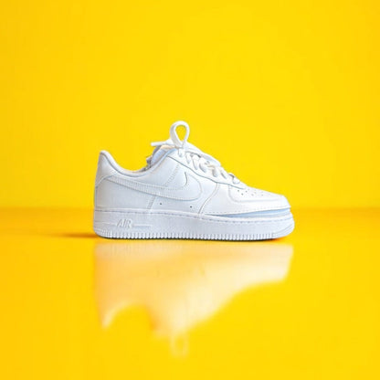 A white shoe with a zipper on a yellow background. The shoe is zipped shut