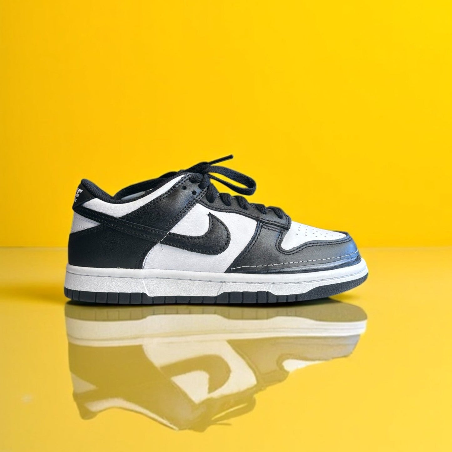 A pair of kids white and white shoes with a zipper. The shoe is zipped shut