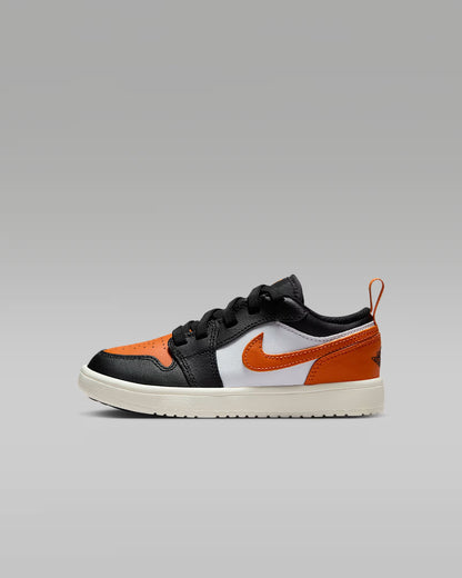 Black, orange, and white sneaker on a gray background