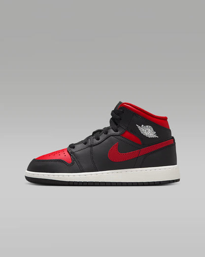 A black and red Big Kids' Mid top sneaker with a white sole