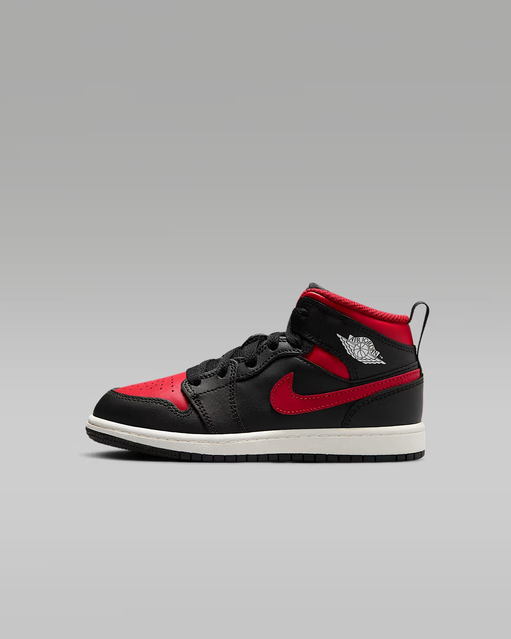 A little kid's Mid top sneaker with a black base color and red details