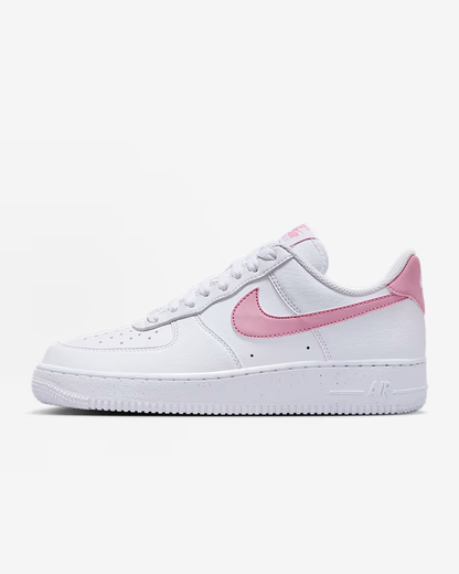 White sneaker with pink swoosh on a white background