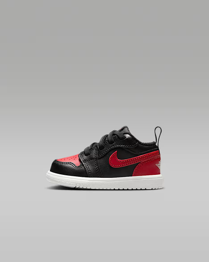 Black and red sneaker with a white sole on a gray background