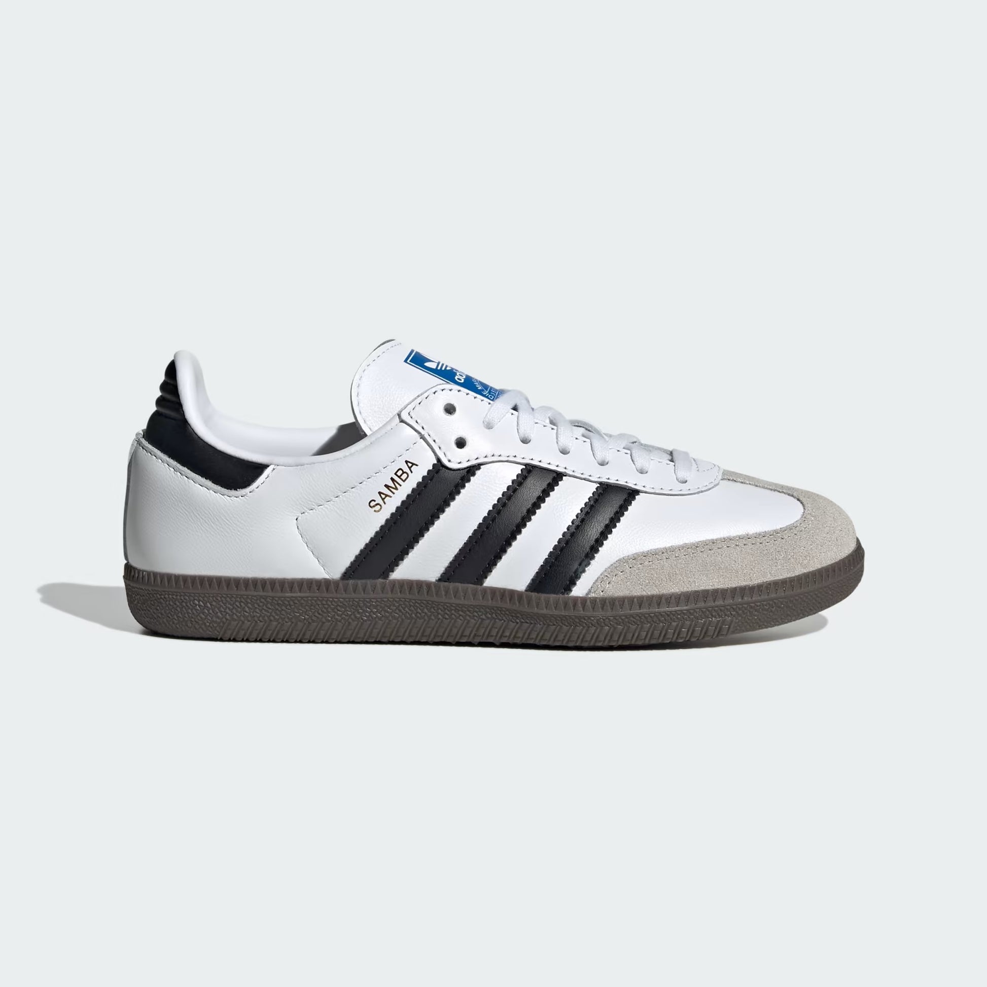 White sneaker with black stripes on a light gray background