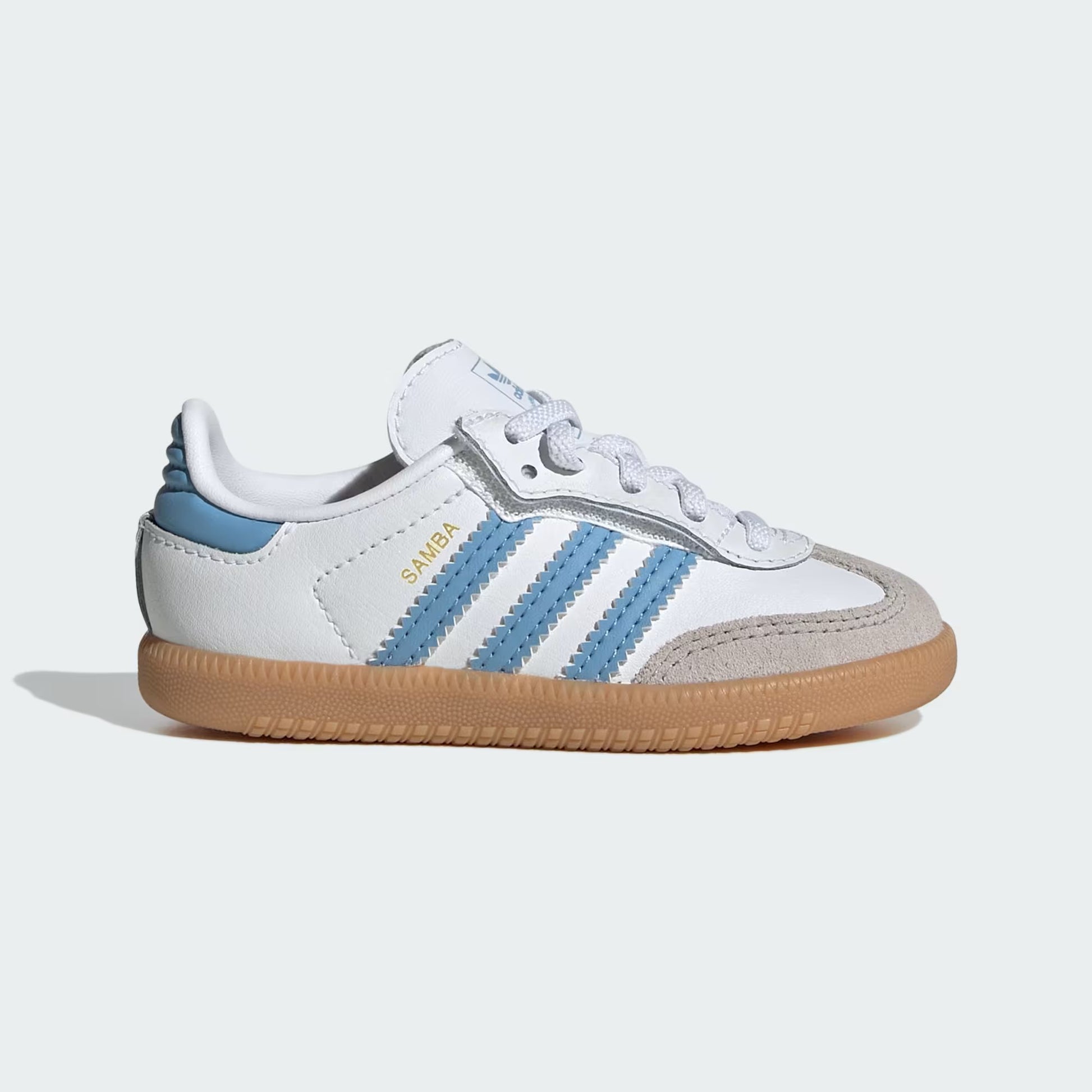 White and blue sneaker with brown sole on a light gray background