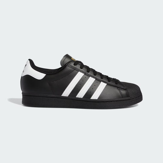 Black sneaker with white stripes on a light gray background