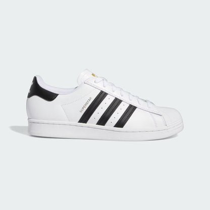 White Superstar sneaker with black stripes on a light gray background