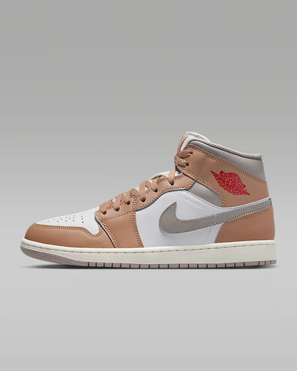 Brown and white sneaker with a logo on a gray background