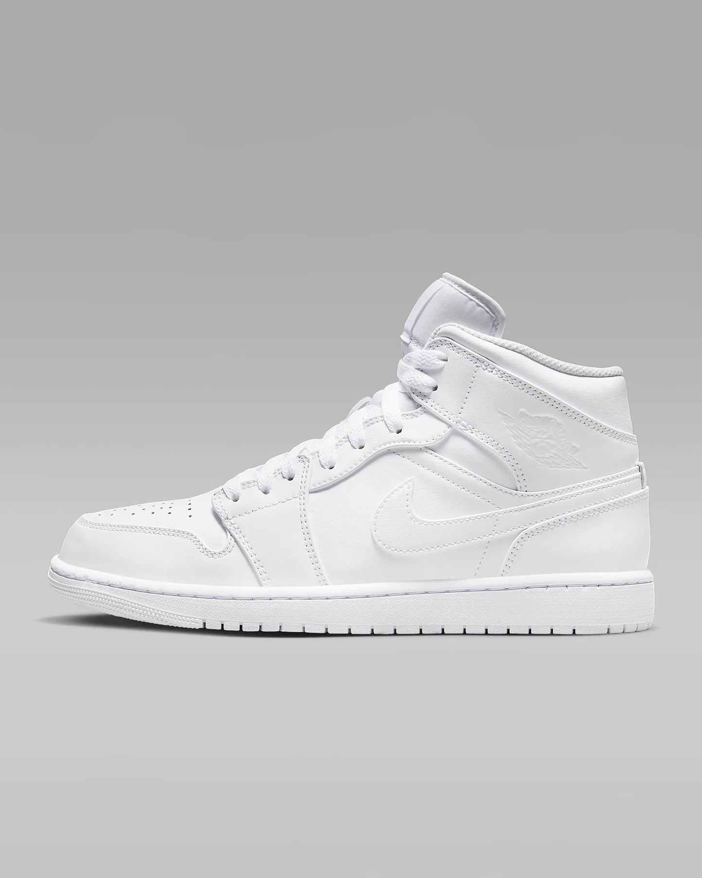 A pair of white Jordan 1 Mid sneakers