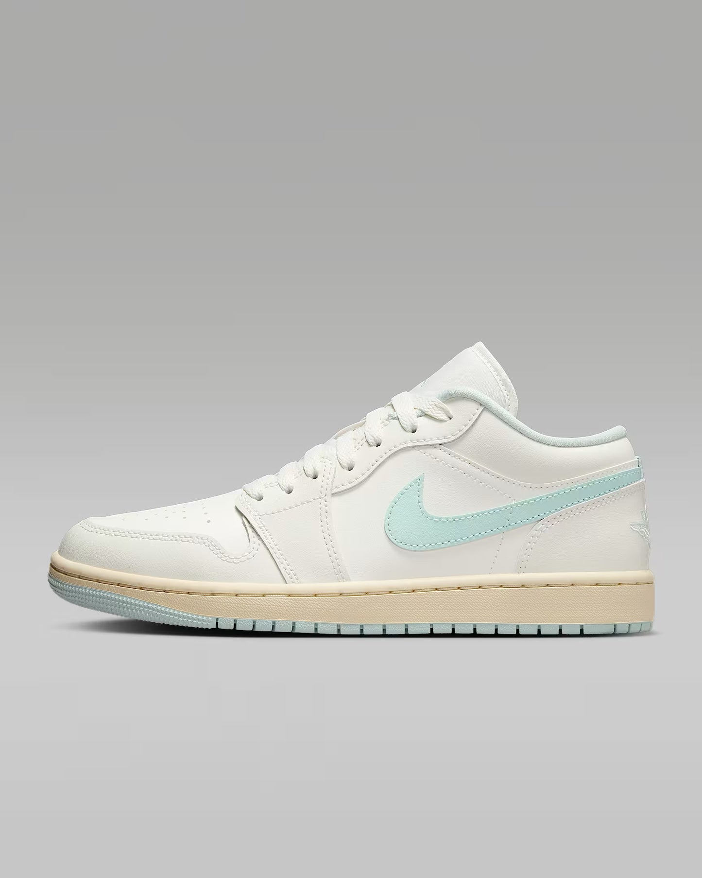 White sneaker with a light blue logo on a gray background