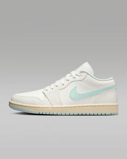 White sneaker with a light blue logo on a gray background